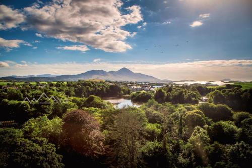 an aerial view of a river and trees with mountains in the background at Asgard Apartments in Westport