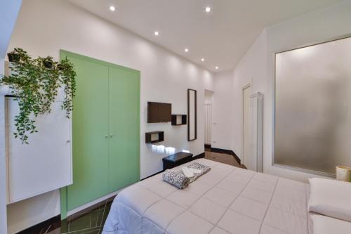 a bedroom with a large bed and a green wall at Residenza Napoli Centrale in Naples