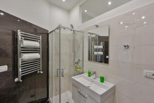 a bathroom with a sink and a shower and a mirror at Residenza Napoli Centrale in Naples