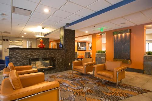 a waiting room with chairs and a fireplace at Holiday Inn Express & Suites Nashville Southeast - Antioch, an IHG Hotel in Antioch