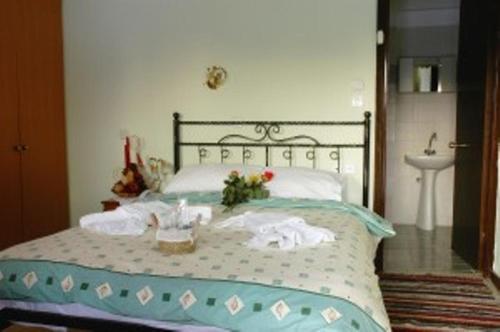 een bed met handdoeken en een wastafel in een slaapkamer bij Villa Rosa in Antartiko