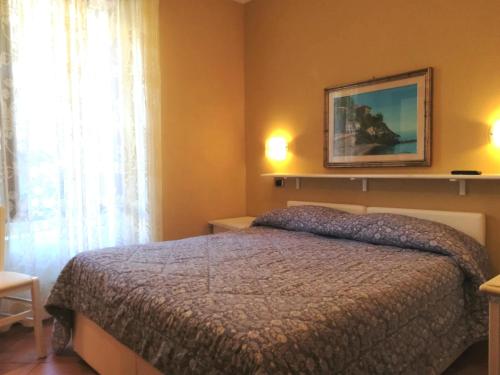 a bedroom with a bed and a picture on the wall at affittacamere la loggia in Levanto