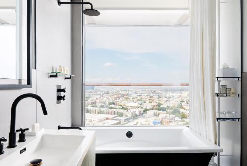 a bathroom with a large window overlooking the ocean at The William Vale in Brooklyn