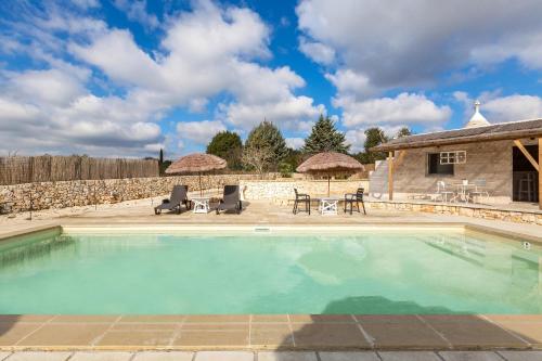 a swimming pool in front of a house at B&B Mariano in Ceglie Messapica