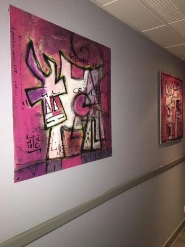 two pieces of art hanging on a wall at Hotel restaurant La Pêcherie - Le manoir d'à coté - Les 5 ruches -Logis hôtels in Courseulles-sur-Mer