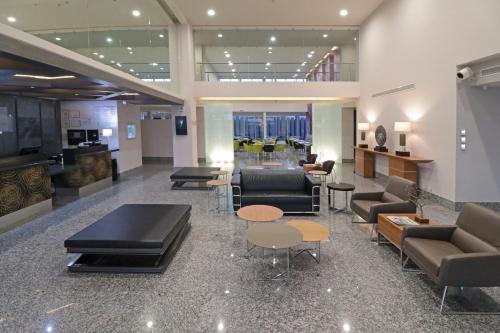 a lobby with couches and tables in a building at Holiday Inn Express Hotel & Suites Hermosillo, an IHG Hotel in Hermosillo