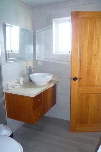 a bathroom with a sink and a toilet and a window at The blue lagoon of the Caribbean Sea. Velero 205.Cadaques Caribe in La Fragata