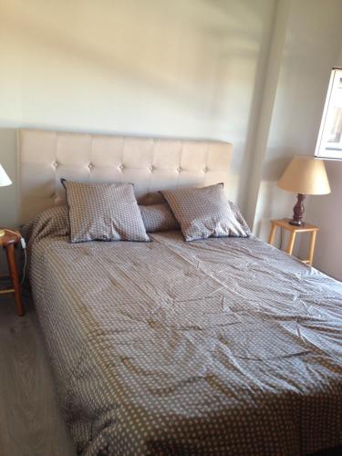 a bedroom with a large bed with two pillows at lanton in Lanton