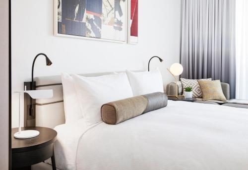 a white bed with a white comforter and pillows at The William Vale in Brooklyn