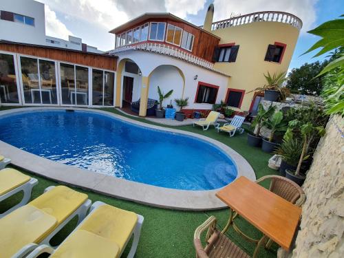 a swimming pool in front of a house at Ocean View Lagos in Lagos