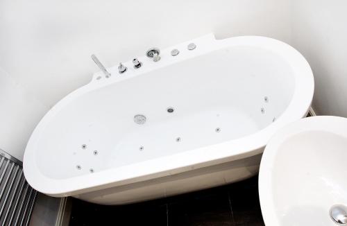 a bathroom with a white sink next to a toilet at Boutique 25 in Skipton