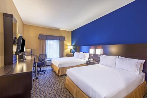a hotel room with two beds and a television at Holiday Inn Express Hotel & Suites Houston-Downtown Convention Center by IHG in Houston
