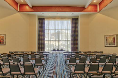 a conference room with chairs and a large window at Holiday Inn Express Hotel & Suites Houston-Downtown Convention Center by IHG in Houston