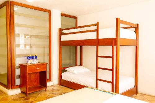 a bedroom with two bunk beds and a mirror at Acoma in Otavalo