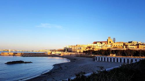 a view of a beach with buildings and the ocean at Hotel Porto Badisco in Porto Badisco