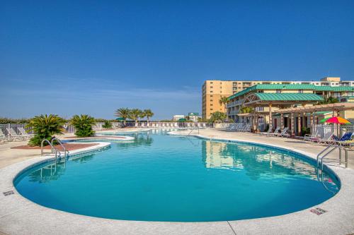 a large blue swimming pool in a resort at Plantation East III in Gulf Shores