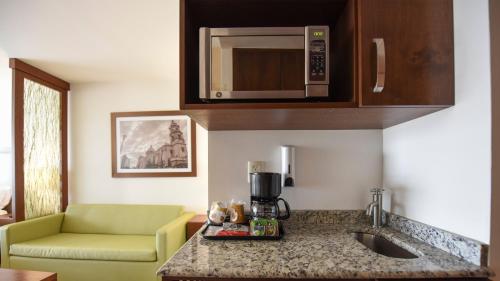a kitchen with a counter top with a coffee maker at Holiday Inn Express and Suites Celaya by IHG in Celaya