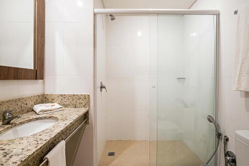 a bathroom with a shower and a sink at Slim Curitiba Av das Torres in Curitiba