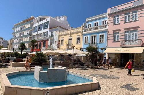 a fountain in the middle of a street with buildings at Townhouse w Beautiful terrace - 360 degrees views! in Lagos
