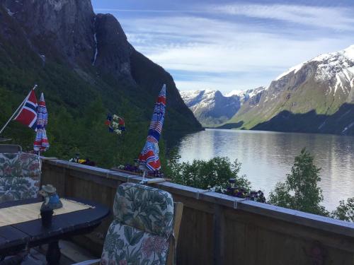 a balcony with a view of a lake and mountains at Iris Vedal in Nauste