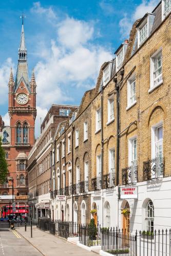 a city street with a clock tower and buildings at Fairway Hotel in London