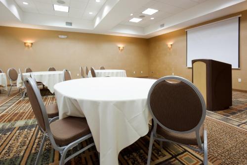 a conference room with a white table and chairs at Holiday Inn & Suites Green Bay Stadium by IHG in Green Bay
