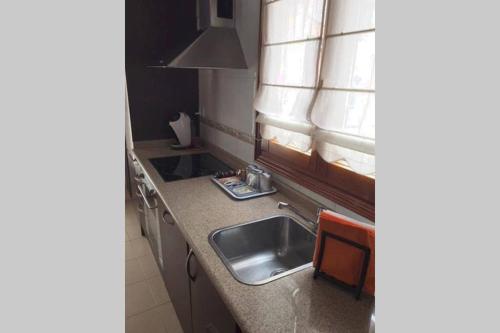 a kitchen with a sink and a window at Sare Enea in Bermeo