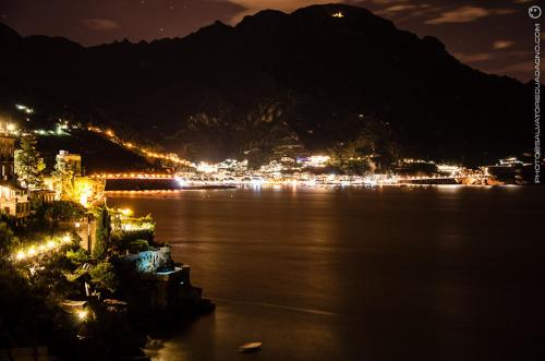 a view of a city at night with a mountain at Eden Holiday in Minori