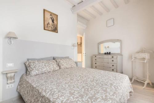 a white bedroom with a bed and a dresser at Happy Florence San Niccolò n.2 in Florence