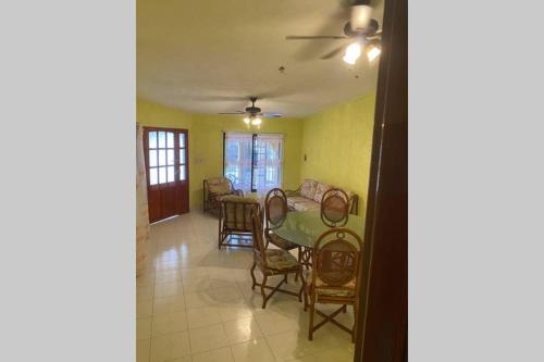 a dining room and living room with a table and chairs at Casa Colonial in Campeche