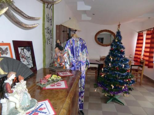 a christmas tree on a table in a room at Pension Casa Samurai in Braşov