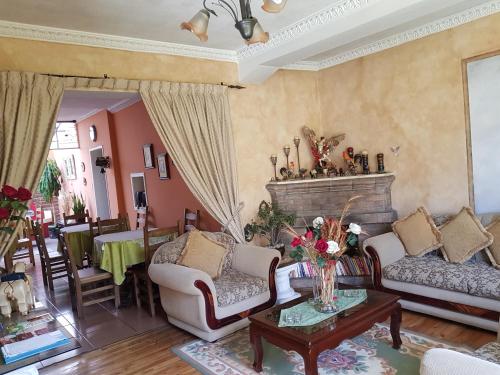 a living room with two couches and a table at Petite Maison in Quito