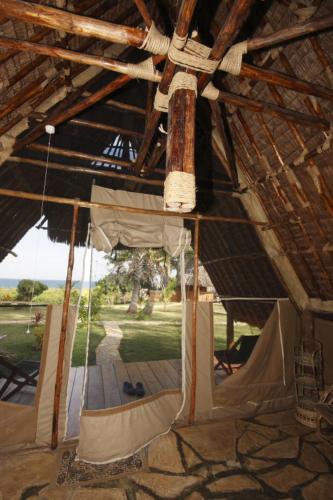 a cross hanging from the ceiling of a tent at Bahari Pori Resort in Pangani