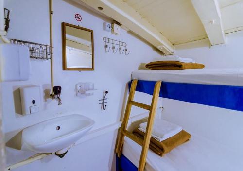 a bathroom with a sink and a ladder in a boat at Rhythm Floating Hostel - Zadar in Zadar