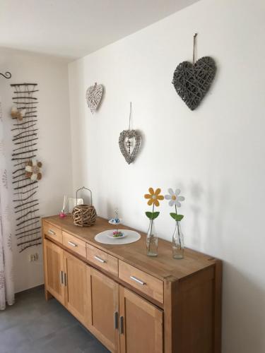 a bathroom with a sink and hearts on the wall at Ferienwohnung Magdalena in Bodenmais