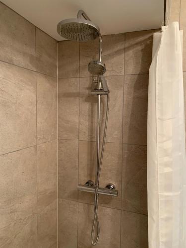 a shower with a shower head in a bathroom at Sea View Terrace in Newcastle