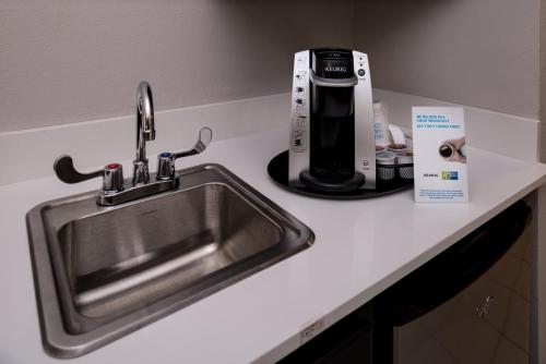 a kitchen counter with a sink and a coffee maker at Holiday Inn Express & Suites Bucyrus by IHG in Bucyrus