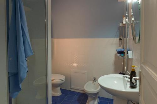 a bathroom with a sink and a toilet and a shower at Opera Prima 28 in Palermo