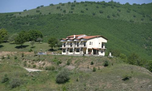 a large house on top of a hill at Guesthouse Mirihos in Vlásti