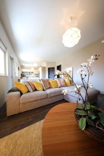 a living room with a couch and a table at Luxury Apartment RougeMarin in Pakoštane