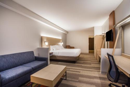a hotel room with a bed and a couch at Holiday Inn Express & Suites Lexington Park California by IHG in California