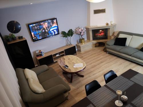 a living room with a couch and a table and a tv at Red Rose Apartament -Parking -Taras- Faktura VAT in Kielce