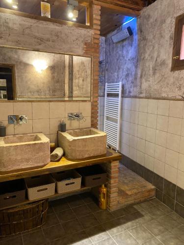 a bathroom with two sinks on a wooden counter at CASA LA JUDERÍA in Gea de Albarracín