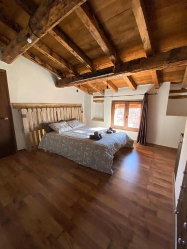 a bedroom with a bed and a wooden floor at CASA LA JUDERÍA in Gea de Albarracín