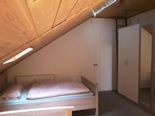 a bed in a room with a loft at Monteurwohnung - Business Apartment in Wertheim