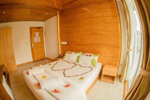 a bedroom with a bed with a heart made up at PERLA Dhangethi in Dhangethi