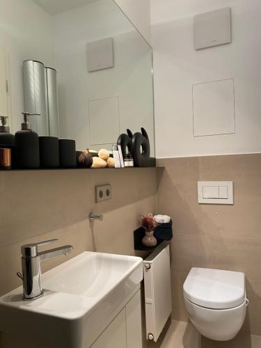 a bathroom with a sink and a toilet at Grace-Design-Apartment - very central in Munich
