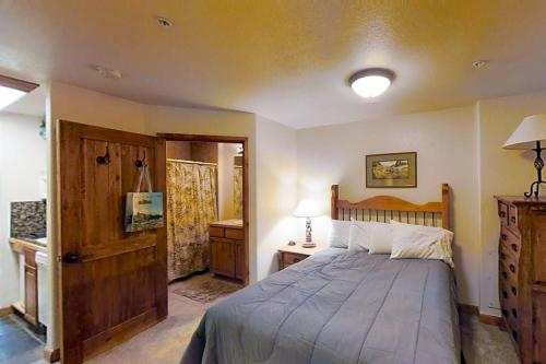 a bedroom with a large bed with a wooden headboard at Romance at Riverbends' Snowflake Lift in Breckenridge