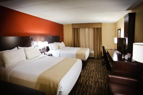 a hotel room with two beds and a television at Pearl Street Hotel in La Crosse