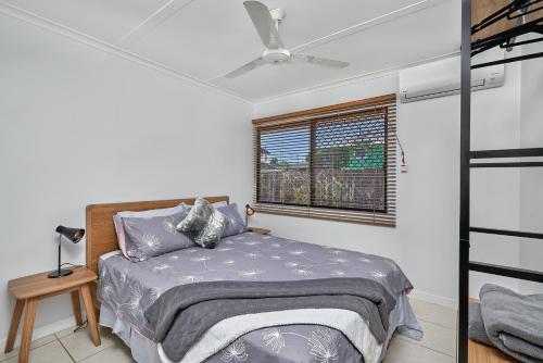 a bedroom with a bed and a window at The Red Sparrow 2 in Cairns
